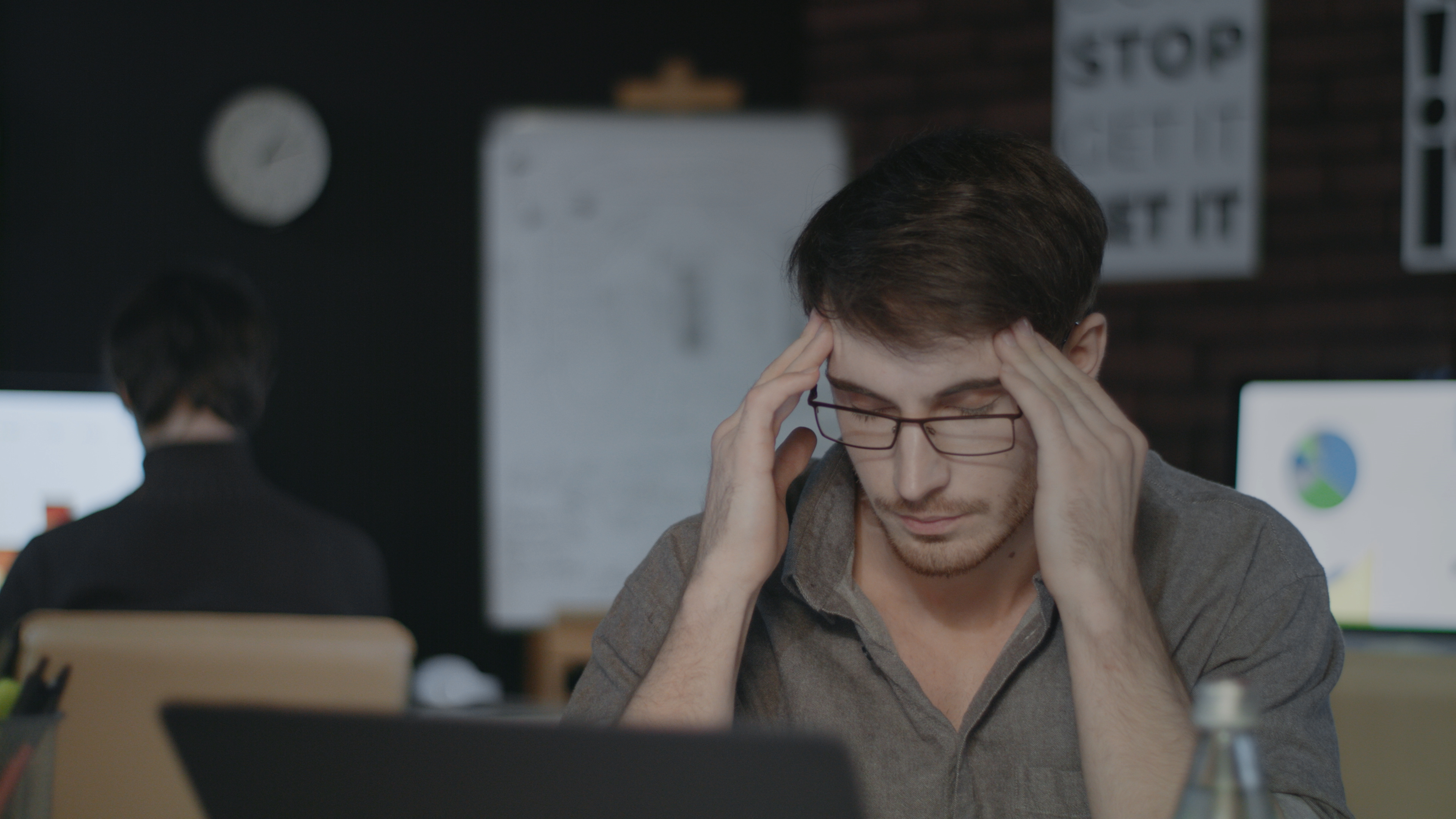 An IT generalist working late at a laptop — the kind of person being told they can now build an integration in an afternoon.